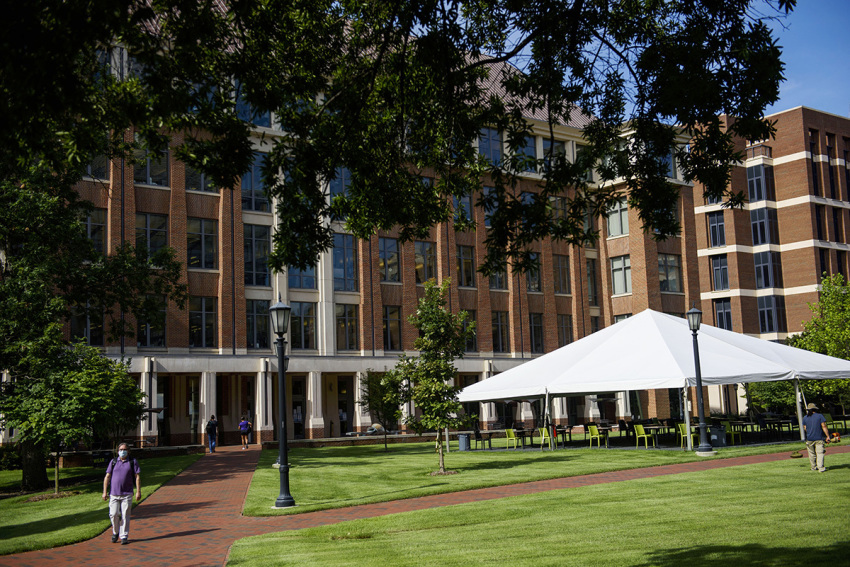 Students and faculty walk through an open area outside the School of Medicine on the campus of the University of North Carolina at Chapel Hill on August 18, 2020, in Chapel Hill, North Carolina.