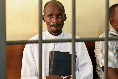 Wealthy and high-profile televangelist Ezekiel Odero, (L) head of the New Life Prayer Centre and Church, sits in the dock before the hearing of his case on suspected murder, aiding suicide, abduction, radicalisation, crimes against humanity, child cruelty, fraud and money laundering, at the Shanzu law courts in Mombasa on May 4, 2023. - A prominent Kenyan pastor faces a court hearing on May 4, 2023, in connection with the horrific discovery last month of dozens of bodies in mass graves. Ezekiel Odero, a wealthy televangelist who boasts a huge following, is being investigated on a raft of charges including murder, aiding suicide, abduction, radicalisation, crimes against humanity, child cruelty, fraud and money laundering. Prosecutors accuse Odero of links to cult leader Paul Nthenge Mackenzie, who is in custody facing terrorism charges over the deaths of more than 100 people, many of them children.