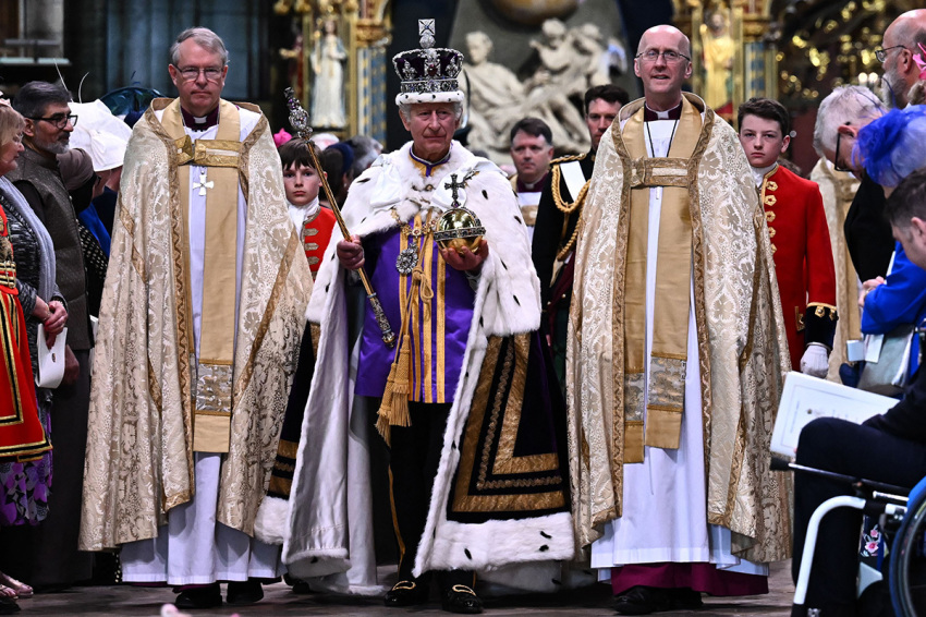Britain's King Charles III wearing the Imperial state Crown carrying the Sovereign's Orb and Sceptre leaves Westminster Abbey after the Coronation Ceremonies in central London on May 6, 2023. - The set-piece coronation is the first in Britain in 70 years, and only the second in history to be televised. Charles will be the 40th reigning monarch to be crowned at the central London church since King William I in 1066. Outside the U.K., he is also king of 14 other Commonwealth countries, including Australia, Canada and New Zealand.