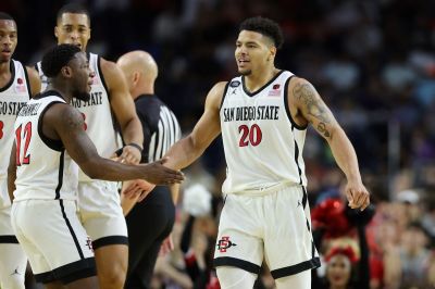 Matt Bradley #20 of the San Diego State Aztecs celebrates with Darrion Trammell #12 during the second half against the Florida Atlantic Owls during the NCAA Men's Basketball Tournament Final Four semifinal game at NRG Stadium on April 01, 2023 in Houston, Texas.