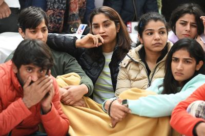 (L-3R) Indian wrestlers Bajrang Punia, Anshu Malik, Vinesh Phogat and Sakshi Malik along with others wrestlers take part in an ongoing protest against the Wrestling Federation of India (WFI), in New Delhi on January 19, 2023, following allegations of sexual harassment to athletes by members of the WFI. Triple Commonwealth Games gold medallist Vinesh Phogat, one of India's most decorated women wrestlers, has accused her federation chief and several coaches of sexually harassing multiple athletes.