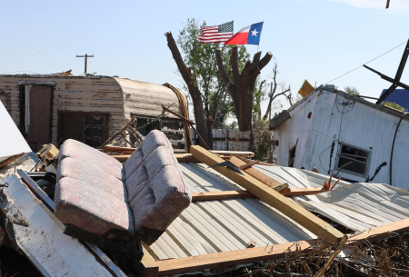Flags fly above the destruction left in the wake of a tornado that devastated Perryton, Texas, on June 15, 2023.