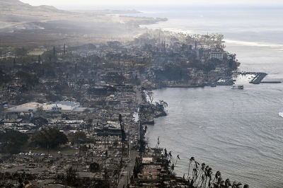 An aerial image taken on August 10, 2023, shows destroyed homes, buildings and the harbor area burned to the ground in Lahaina in the aftermath of wildfires in western Maui, Hawaii. At least 53 people have died after a fast-moving wildfire turned Lahaina to ashes, officials said August 9, as visitors asked to leave the island of Maui found themselves stranded at the airport. The fires began burning early August 8, scorching thousands of acres and putting homes, businesses and 35,000 lives at risk on Maui, the Hawaii Emergency Management Agency said in a statement.