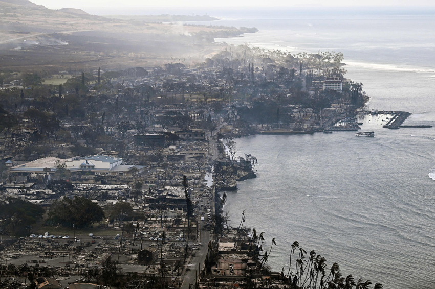 An aerial image taken on August 10, 2023, shows destroyed homes, buildings and the harbor area burned to the ground in Lahaina in the aftermath of wildfires in western Maui, Hawaii. At least 53 people have died after a fast-moving wildfire turned Lahaina to ashes, officials said August 9, as visitors asked to leave the island of Maui found themselves stranded at the airport. The fires began burning early August 8, scorching thousands of acres and putting homes, businesses and 35,000 lives at risk on Maui, the Hawaii Emergency Management Agency said in a statement.