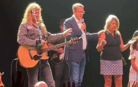 Spokane Mayor Nadine Woodward (R) receives prayer from Pastor Matt Shea (C) of On Fire Ministries, as Sean Feucht, a conservative musician and activist, prays along during a "Let Us Worship" event in the city on August 20, 2023.