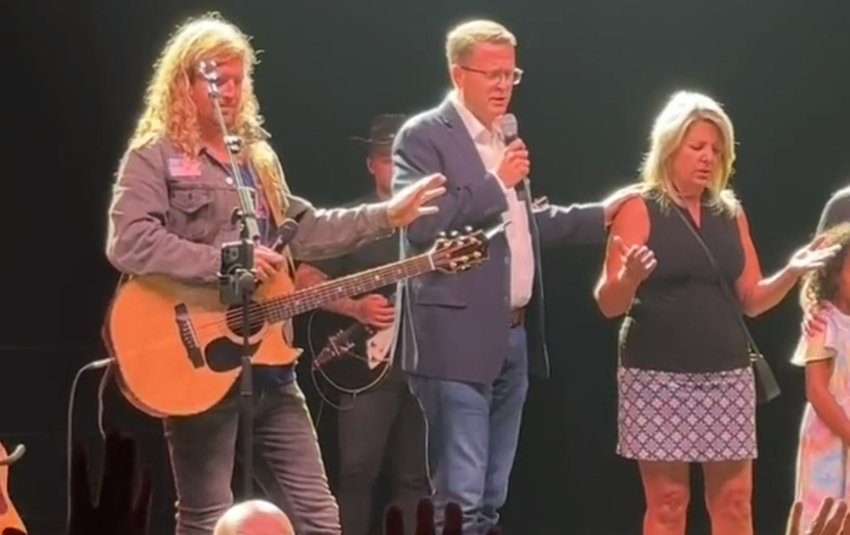 Spokane Mayor Nadine Woodward (R) receives prayer from Pastor Matt Shea (C) of On Fire Ministries, as Sean Feucht, a conservative musician and activist, prays along during a "Let Us Worship" event in the city on August 20, 2023.