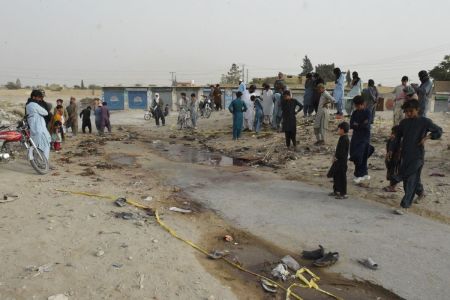 People gather at the site of a suicide bomb attack that targeted a procession marking the birthday of Islam's Prophet Mohammed in Mastung district on Sept. 29, 2023. More than 50 people were killed and dozens more wounded in Pakistan's Balochistan province on Sept. 29 by a suicide bomber targeting a procession marking the birthday of Islam's Prophet Mohammed, officials said.
