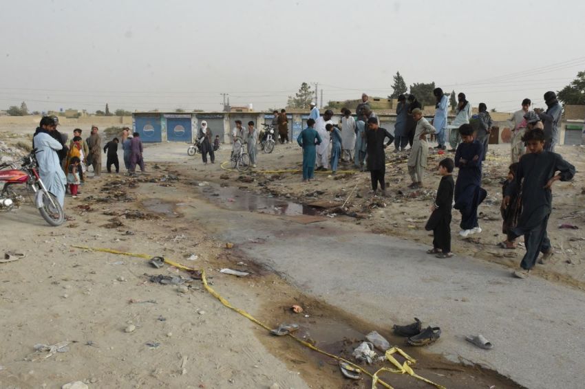 People gather at the site of a suicide bomb attack that targeted a procession marking the birthday of Islam's Prophet Mohammed in Mastung district on Sept. 29, 2023. More than 50 people were killed and dozens more wounded in Pakistan's Balochistan province on Sept. 29 by a suicide bomber targeting a procession marking the birthday of Islam's Prophet Mohammed, officials said.