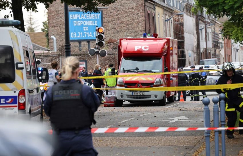 Emergency responders including firefighters and medical workers stand next to their vehicles parked near the Gambetta high school in Arras, northeastern France on Oct. 13, 2023, after a teacher was killed and two other people severely wounded in a knife attack. A man of Chechen origin stabbed to death a teacher and severely wounded two other adults on Oct.13 at a school in northeastern France, with prosectors opening a probe into a suspected act of terror.