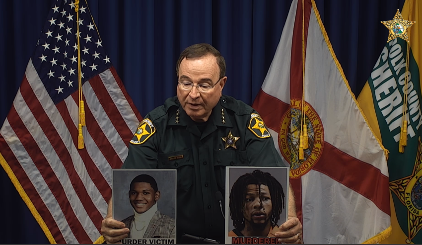 Polk County Sheriff Grady Judd holds up photos of murder victim, 20-year-old Roderick Wilson Jr. (L) and murder suspect, 22-year-old Taquion "Quan" Cotton (R), at a press conference in Florida on October 23, 2023.