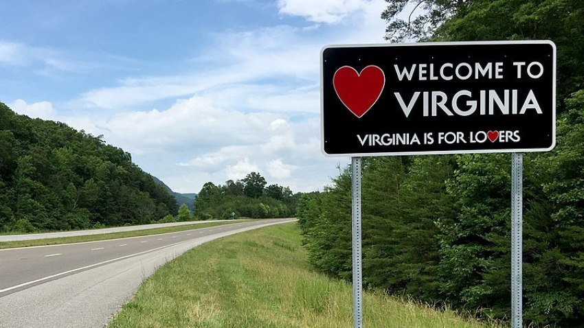 A "Welcome to Virginia" sign sits along eastbound U.S. Route 58 entering Lee County, Virginia, from Claiborne County, Tennessee