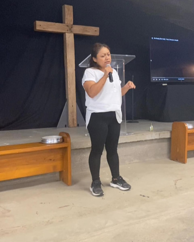 Former witch Herminia Galvez discovered Christ and turned away from the Occult in 2010. In the photo she can be seen sharing her testimony to Christ at a church event.