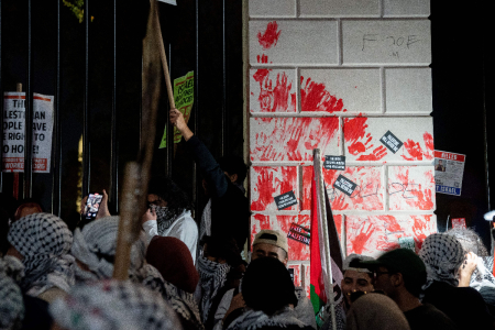 Demonstrators leave red hand prints on the fence in front of the White House during a rally in support of Palestinians in Washington, D.C., on November 4, 2023.