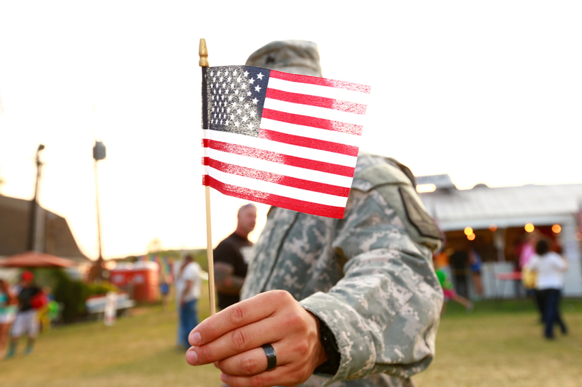 U.S. veteran holding American flag.