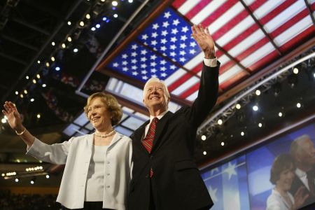 Former U.S. President Jimmy Carter and his wife, Rosalynn, wave to the audience during the Democratic National Convention at the Fleet Center July 26, 2004, in Boston, Massachusetts.