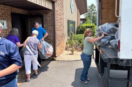 Volunteers with The Tide Ministry pack up shoe donations during their charity event "Your Soles, Their Souls." 