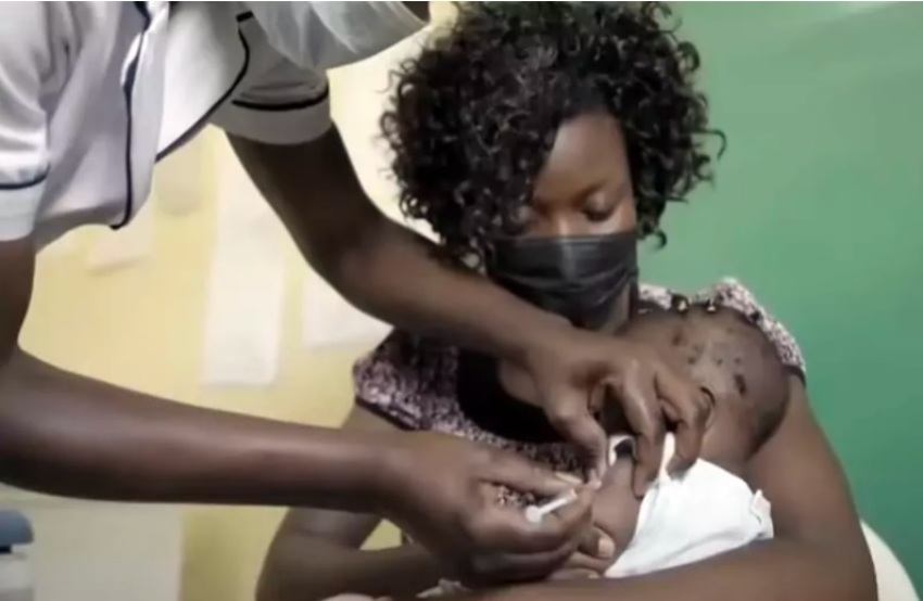 A malaria vaccine is administered to a child in Cameroon.
