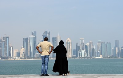 People look at the downtown skyline from the Corniche during the FIFA Arab Cup Qatar on December 15, 2021 in Doha, Qatar.