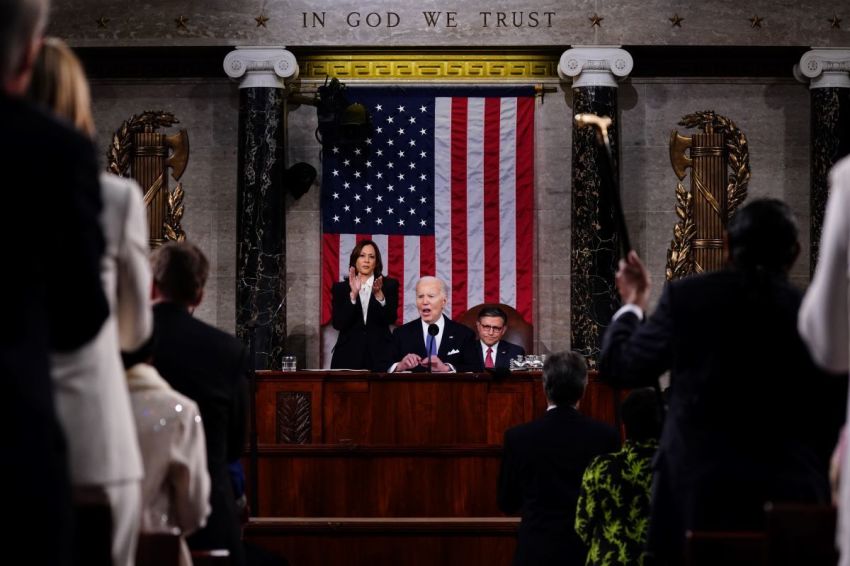 President Joe Biden delivers the annual State of the Union address before a joint session of Congress in the House chamber at the U.S. Capital building on March 7, 2024, in Washington, D.C. Seated to the right of Biden is Speaker of the House Mike Johnson. Vice President Kamala Harris stands to the left of Biden.