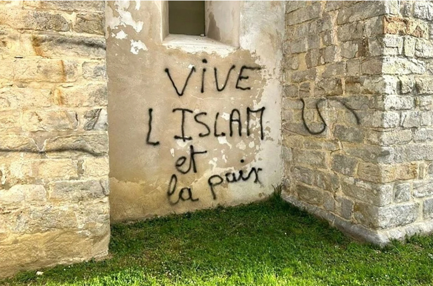 Defaced Catholic church building in Lieusaint, France.