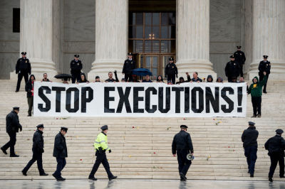 Police officers gather to remove activists during an anti death penalty protest in front of the US Supreme Court January 17, 2017 in Washington, DC.