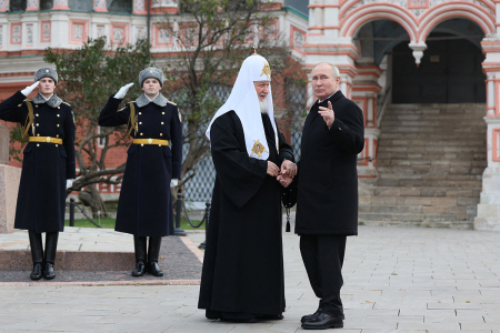 This pool photograph distributed by Russian state owned agency Sputnik shows Russia's President Vladimir Putin and Russian Orthodox Patriarch Kirill (L) talking during a wreath-laying ceremony at the Monument to Minin and Pozharsky on Red Square on the National Unity Day in Moscow on November 4, 2023.