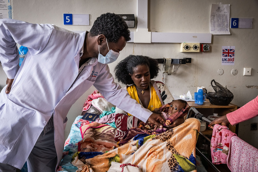 A doctor attends to Alem Degefu Birhan, 29, and her two-month old son, Leul Abraha Gebru, who is suffering from Severe Acute Malnutrition in Ayder Hospital in the city of Mekelle on Feb. 16, 2024, in Tigray Region, Ethiopia. More than 20 million Ethiopians are in need of food aid, according to estimates from the U.N.'s Office for the Coordination of Humanitarian Affairs (UNOCHA). The situation is particularly acute in drought-stricken Tigray, in the country's north, which is still recovering from a two-year war between the Ethiopian government and allied forces on one side, and Tigrayan forces on the other, during which the region's economy was devastated and many were displaced. The combined effects of war and drought have raised the specter of famine, which the federal government in Addis Ababa denies is imminent, saying it is committed to providing aid.