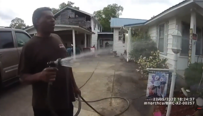 A screenshot from bodycam video released by the Childersburg Police Department shows Pastor Michael Jennings watering his neighbors flowers in Childersburg, Alabama, May 22, 2022, shortly before his arrest.