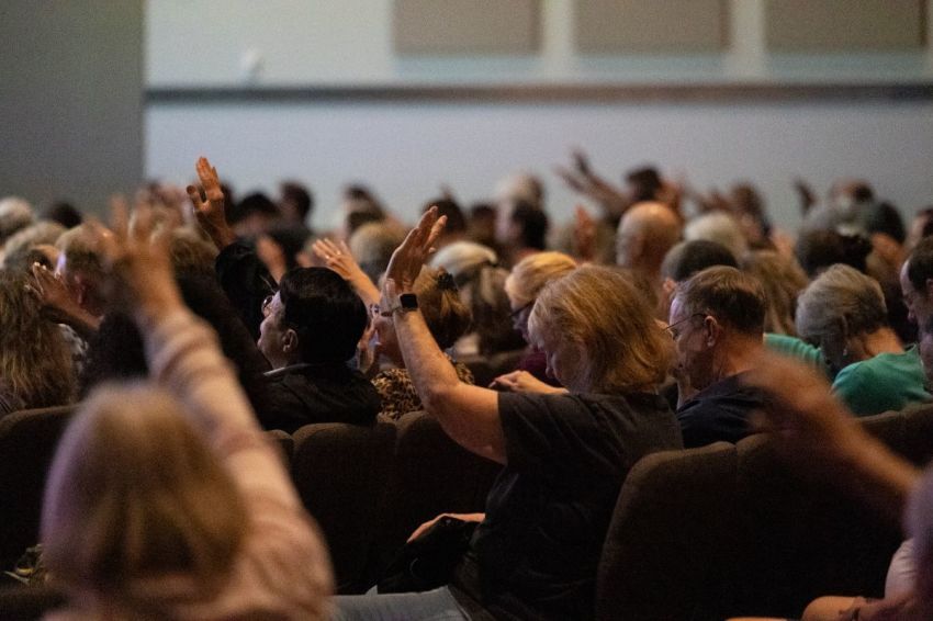 Attendees raise their hands in prayer during the "Unmasking Gender Ideology II" event at Burke Community Church in Burke, Virginia, on Oct. 6, 2024.