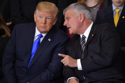 President Donald Trump listens to Franklin Graham during the memorial service for the Rev. Billy Graham in the U.S. Capitol rotunda on Feb. 28, 2018, in Washington, D.C.