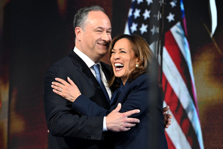 U.S. Second Gentleman Douglas Emhoff (L) hugs U.S. Vice President and 2024 Democratic presidential candidate Kamala Harris after speaking on the fourth and last day of the Democratic National Convention (DNC) at the United Center in Chicago, Ill., on Aug. 22, 2024. Vice President Kamala Harris will formally accepted the party's nomination for president at the DNC which ran from Aug. 19-22 in Chicago.