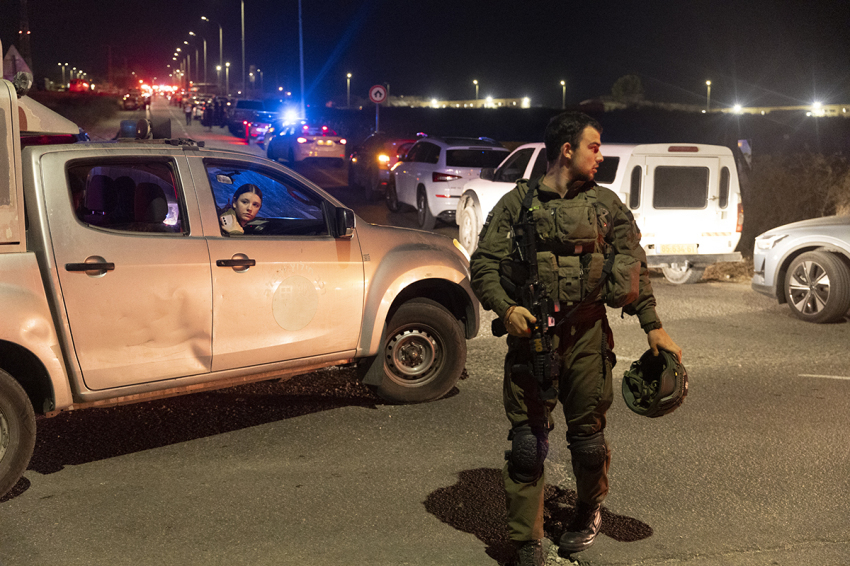 An Israeli soldier secures a road after a drone attack that caused mass casualties on Oct. 13, 2024, in Binyamina, Israel. More than 60 people were reportedly injured near Binyamina, Israel, following a drone strike launched by Hezbollah.