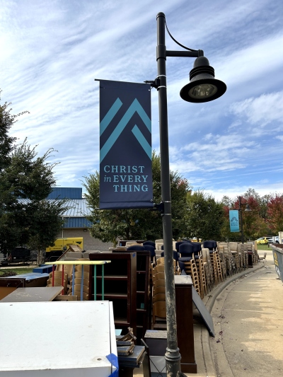 Furniture salvaged from the flood-damaged buildings of Asheville Christian Academy in Swannanoa, N.C., was piled beneath a banner displaying the school's motto,