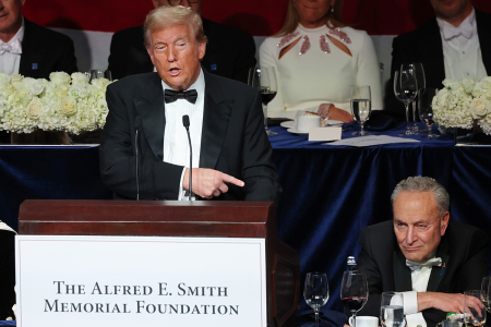 Republican presidential nominee, former U.S. President Donald Trump, points to Senate Majority Leader Chuck Schumer as he speaks during the annual Alfred E. Smith Foundation Dinner at the New York Hilton Midtown on Oct. 17, 2024, in New York City. Trump was the featured speaker with comedian Jim Gaffigan as the master of ceremonies at the the 79th annual Alfred E. Smith Memorial Foundation Dinner. The dinner, a white-tie charity event that benefits Catholic charities, is known for political figures poking fun at one another. The foundation honors the late Alfred E. Smith, former governor of New York and America's first Catholic presidential nominee.