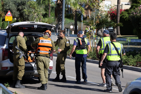 Members of the Israeli security forces walk along a street leading to Prime Minister Benjamin Netanyahu's residence in Caesarea on Oct. 19, 2024. Netanyahu's office said a drone was launched toward his residence on Oct. 19, after the military reported a drone from Lebanon had