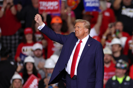Former President and Republican presidential candidate Donald Trump gestures at the end of a campaign rally at PPG Paints Arena in Pittsburgh, Pennsylvania, on Nov. 4, 2024.