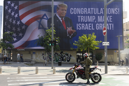 People pass by a congratulatory billboard showing elected U.S. President Donald Trump on Nov. 7, 2024, in Tel Aviv, Israel. In a post on X, Israeli Prime Minister Benjamin Netanyahu has congratulated Donald Trump on 