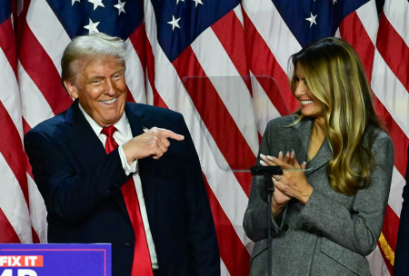 Former U.S. President and Republican presidential candidate Donald Trump points to his wife, former U.S. first lady Melania Trump during an election night event at the West Palm Beach Convention Center in West Palm Beach, Florida, early on Nov. 6, 2024.