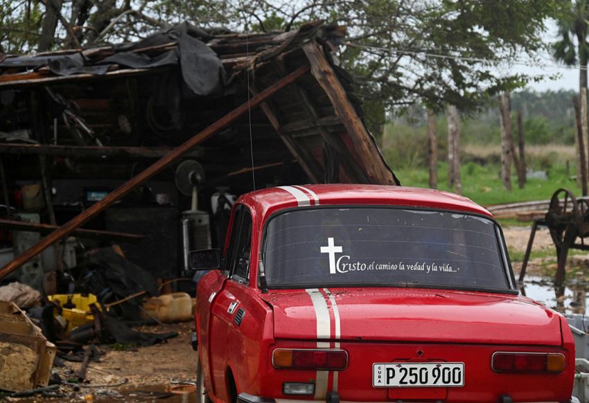 A car is pictured next to the debris of a house after the passage of hurricane Rafael in Batabano, Artemisa province, Cuba, on Nov. 7, 2024. Power was restored to parts of Cuba on Thursday a day after Hurricane Rafael swept over the island, leaving its 10 million inhabitants without electricity for the second time in a month.