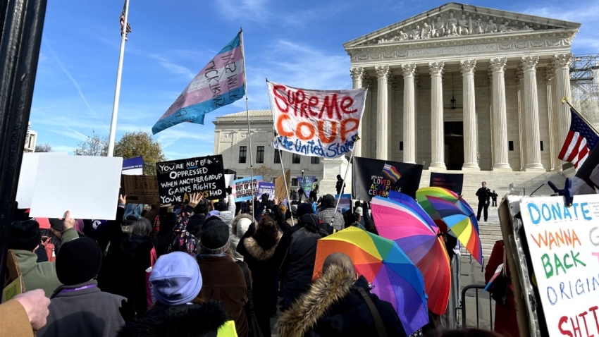 Pro-trans demonstrators display signs outside the U.S. Supreme Court in Washington, D.C., on Dec. 4, 2024.