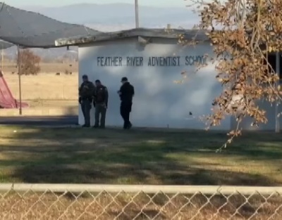 Police officers walk outside of Feather River School of Seventh-Day Adventists in Palermo, California, on Dec. 4, 2024, following a shooting that resulted in two children being wounded and the suspected shooter dying of a self-inflicted gunshot wound.