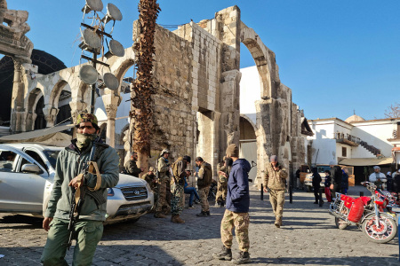 Anti-government gunmen gather outside Damascus's historic Umayyad Mosque in the Old City on Dec. 8, 2024, after Islamist-led rebels declared that they have taken the Syrian capital in a lightning offensive, sending President Bashar al-Assad fleeing and ending five decades of Baath rule in Syria.