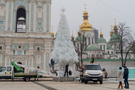 Workers set up a Christmas tree in front of the Bell Tower of Saint Sophia's Cathedral at Sophia Square ahead of Christmas and New Year celebrations in Kyiv on December 4, 2024, amid the Russian invasion of Ukraine.