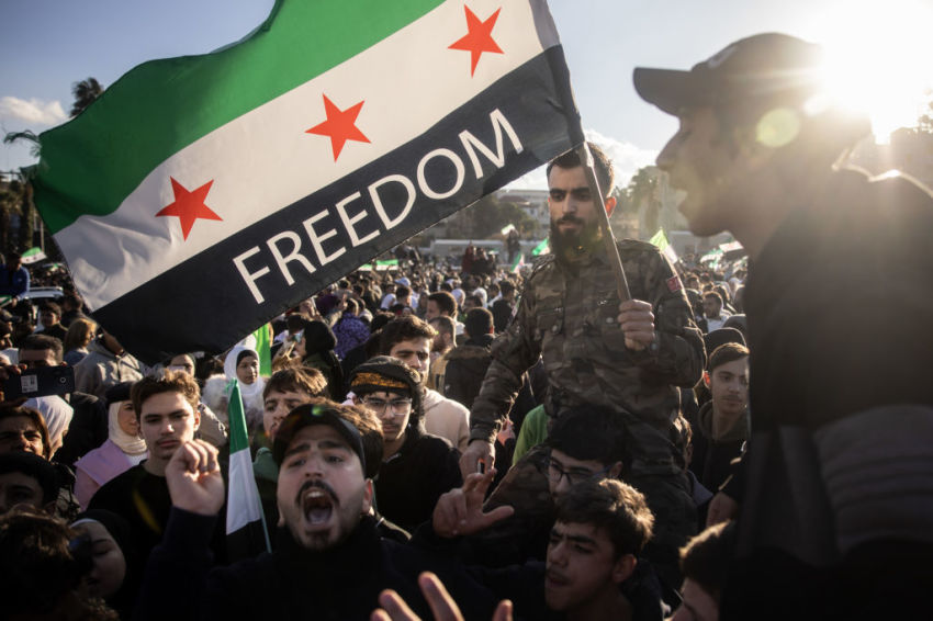 People dance and sing songs as they take part in victory celebrations in Umayyad Square on December 13, 2024 in Damascus, Syria. Rebel forces in Syria have retaken the capital from longtime ruler Bashar al-Assad, who has fled the country for Moscow. The fall of the Assad regime marks a new chapter for Syria, which has been mired in a multi-party civil war since 2011, sparked by the Arab Spring uprisings.