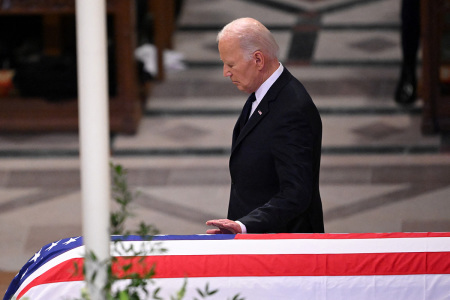 U.S. President Joe Biden touches the casket after delivering the eulogy at the State Funeral Service for former U.S. President Jimmy Carter at the Washington National Cathedral in Washington, D.C., on Jan. 9, 2025.