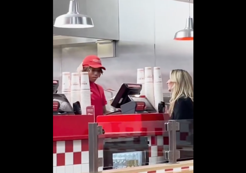 OnlyFans model Bonnie Blue speaks with an employee at a Five Guys restaurant.