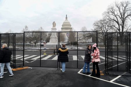 People stand near security checkpoints at the U.S. Capitol on Jan. 17, 2025, in Washington, D.C., three days before the second inauguration of President-elect Donald Trump.