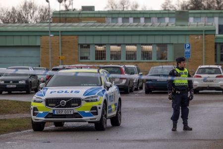 The police stand behind the barricaded area where the school shooting took place.on February 5, 2025 in Orebro, Sweden. On Tuesday a gunman opened fire in an adult education center at Risbergska School, in the Swedish city of Orebro, about 200 kilometers (124 miles) west of the capital, Stockholm. According to police, the attack left at least 11 people dead. The suspect is believed to be among the dead.