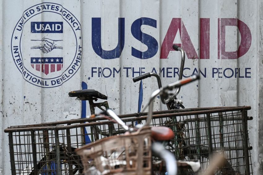 Signage for the US government's humanitarian agency USAID is seen on a cargo container beside a tricycle in Manila on February 4, 2025. The US government's giant humanitarian agency USAID announced it was placing its staff in the United States and around the world on administrative leave as it moved to recall employees from overseas postings.