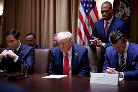 U.S. Secretary of Housing and Urban Development Scott Turner (2nd-R), accompanied by U.S. Secretary of State Marco Rubio (L), U.S. President Donald Trump and U.S. Defense Secretary Pete Hegseth (R), leads a prayer during a cabinet meeting at the White House on Feb. 26, 2025 in Washington, D.C.